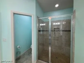 a bathroom with a glass shower door