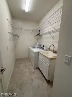 a utility room with sink dryer and washer