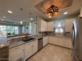 a kitchen with stainless steel appliances granite countertop a sink and cabinets