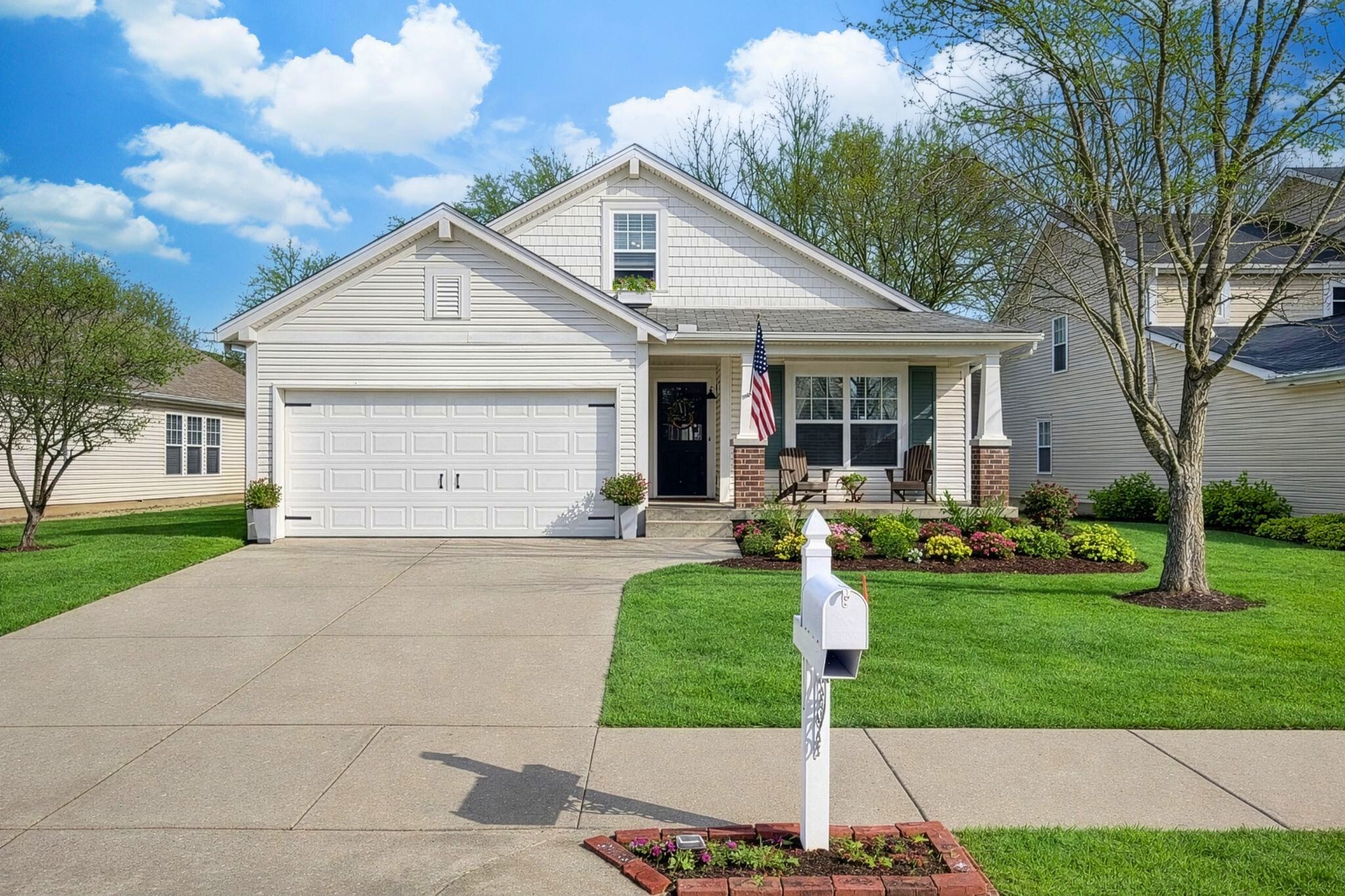 a front view of house with yard and green space