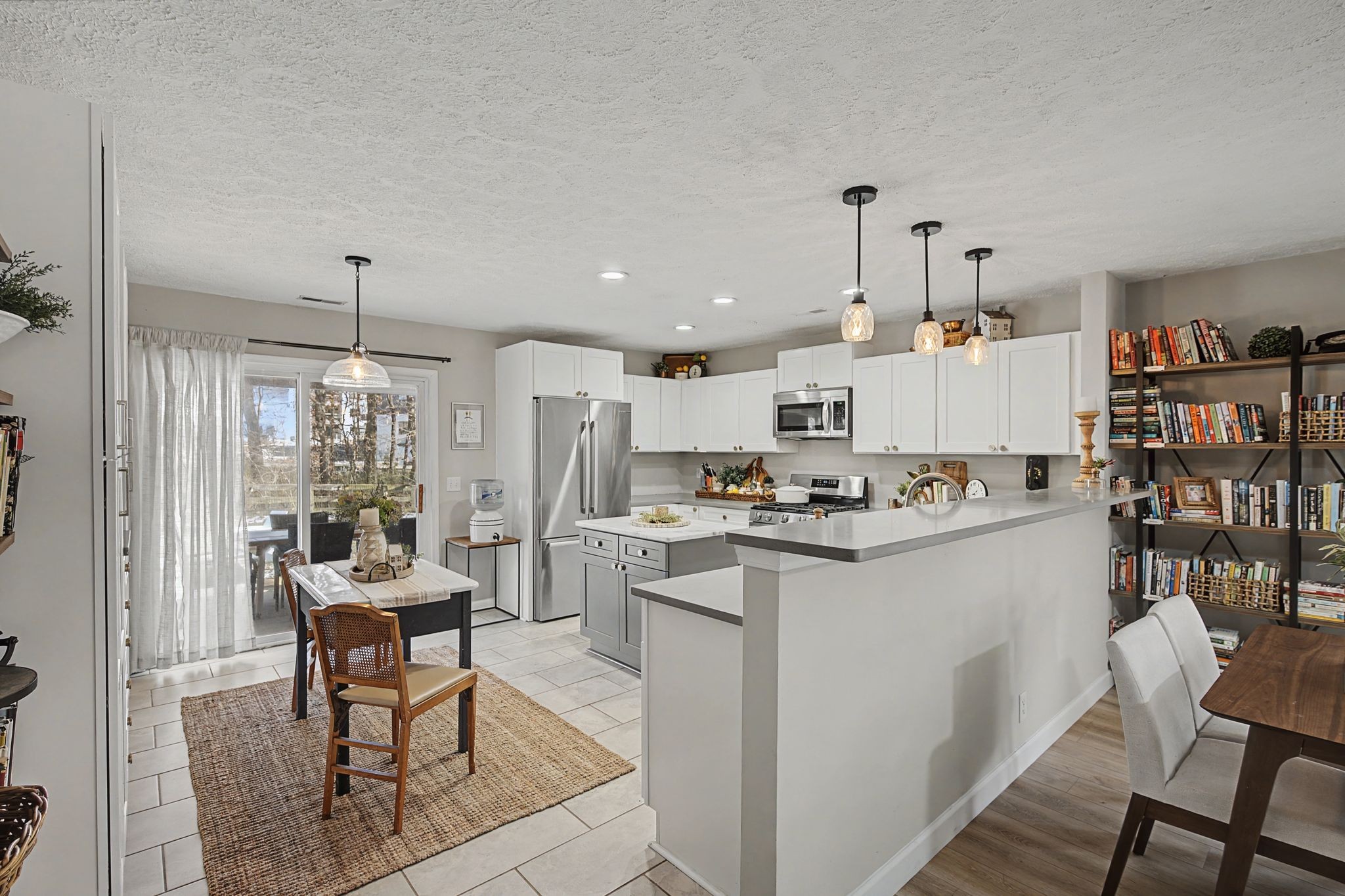 1038 Lexington Farms Drive Spring Hill, TN 37174 - Photo 13 of 34 a kitchen with granite countertop a table chairs stove and cabinets