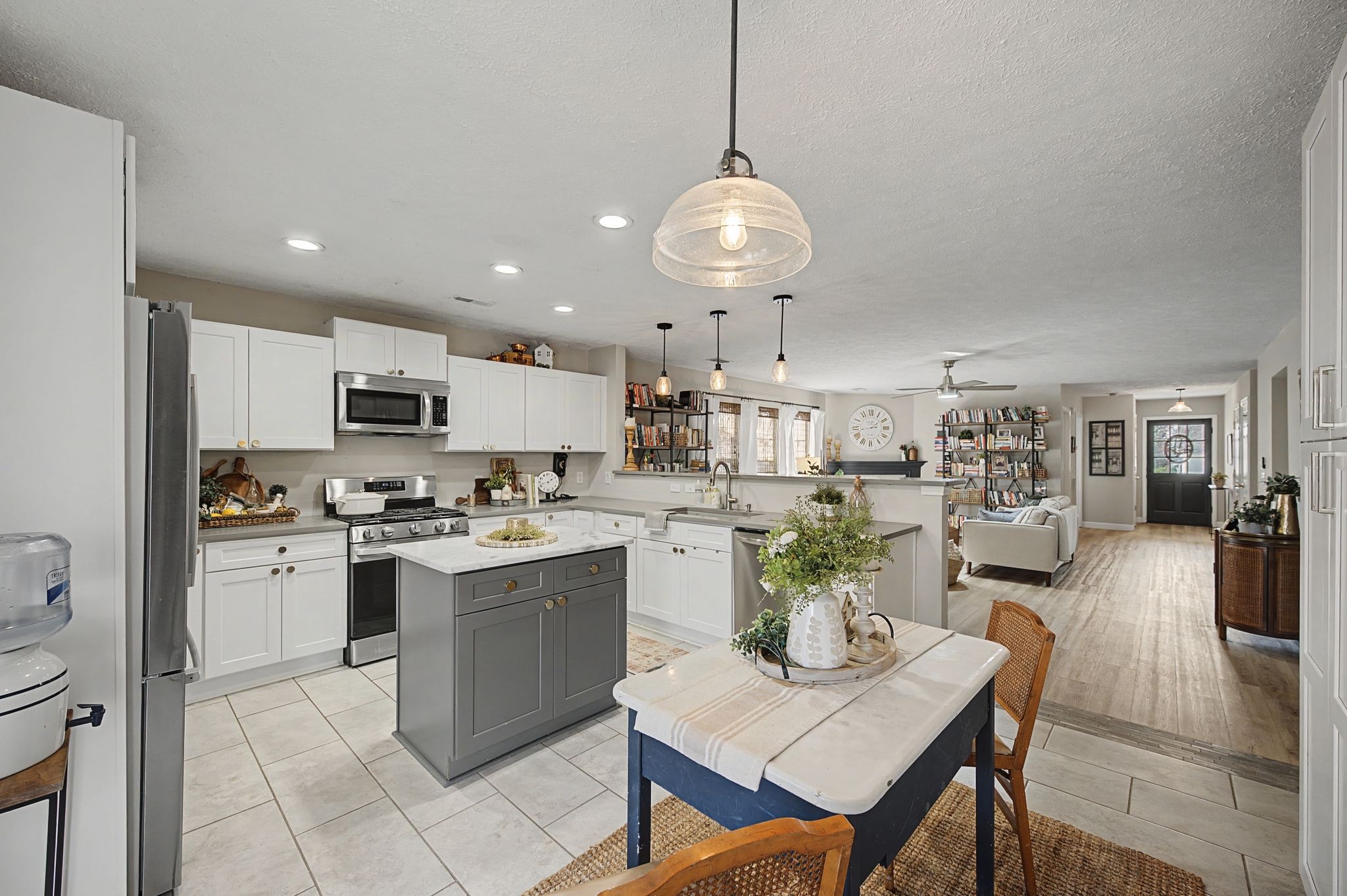1038 Lexington Farms Drive Spring Hill, TN 37174 - Photo 14 of 34 a kitchen with a dining table cabinets stainless steel appliances and a chandelier