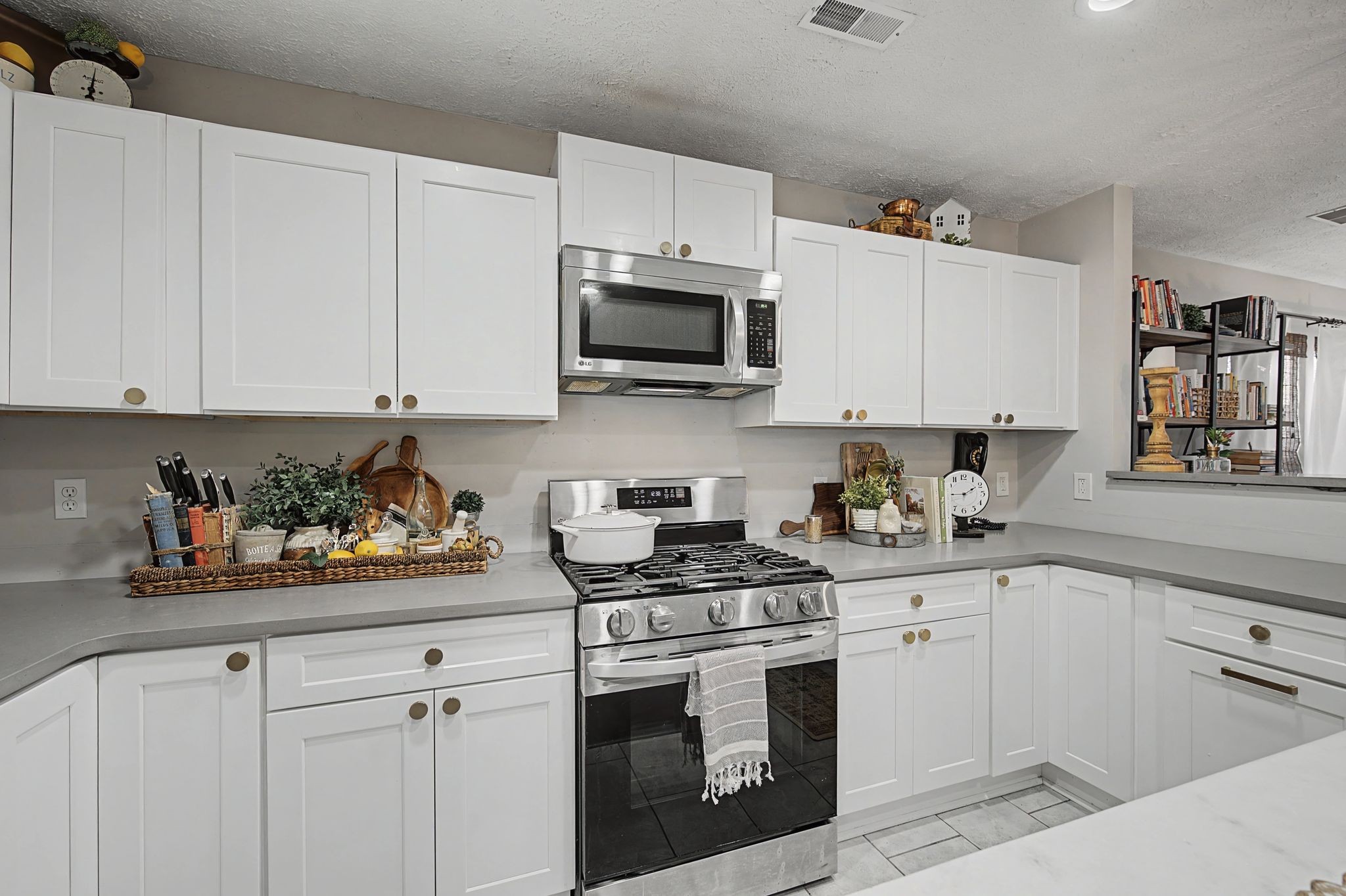 1038 Lexington Farms Drive Spring Hill, TN 37174 - Photo 16 of 34 a kitchen with stainless steel appliances white cabinets and a sink