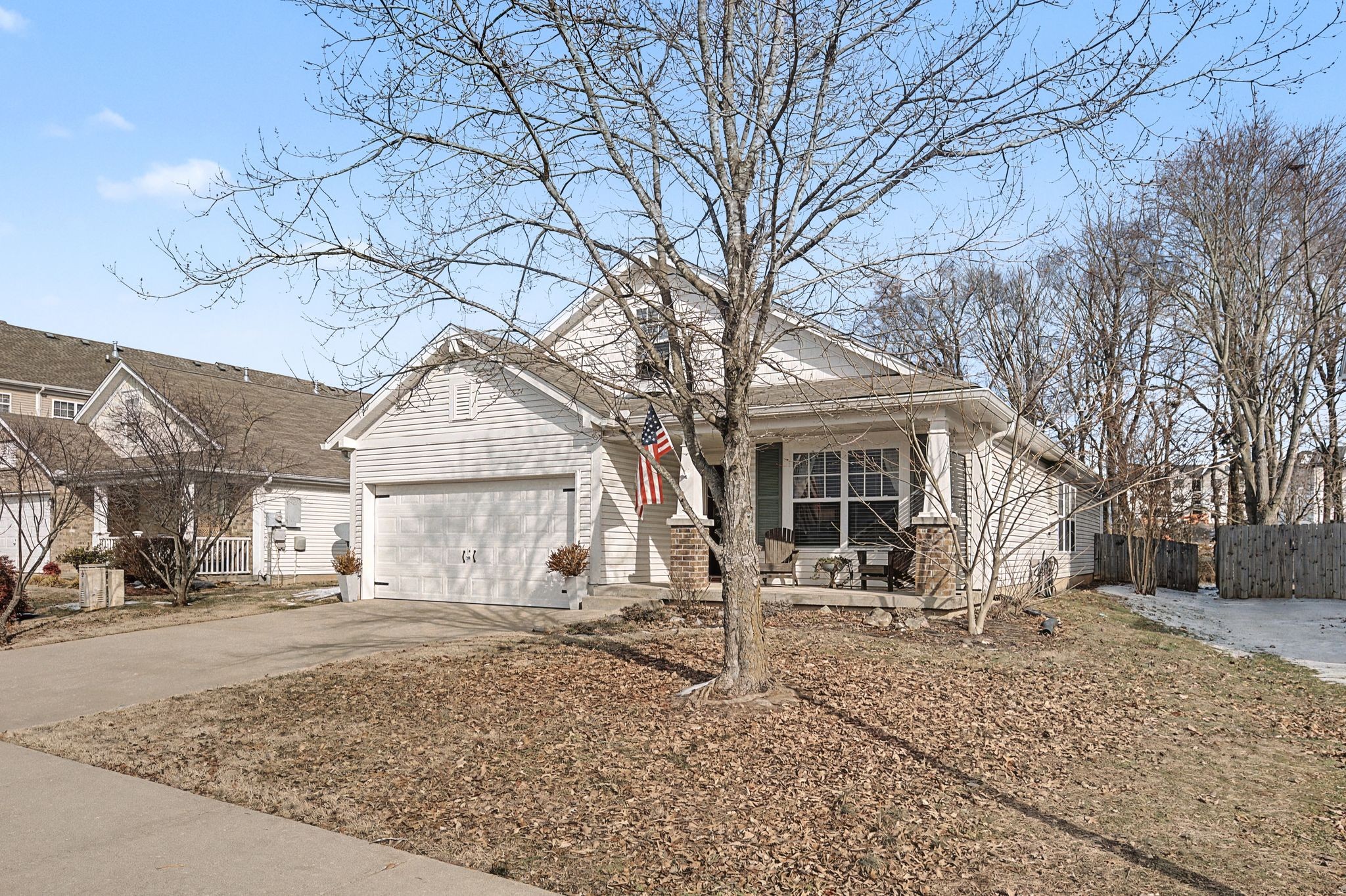 1038 Lexington Farms Drive Spring Hill, TN 37174 - Photo 3 of 34 a front view of a house with a yard covered in snow