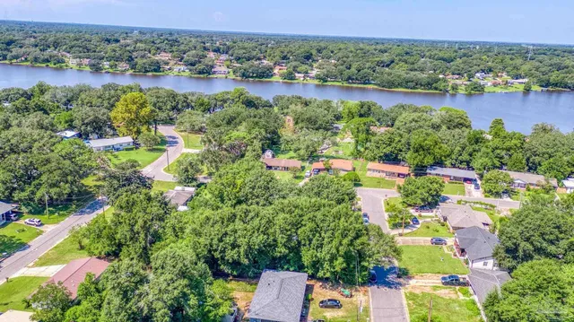 an aerial view of residential house with outdoor space and lake view