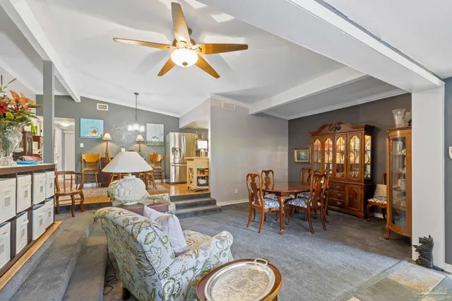 a view of a dining room with furniture and a chandelier