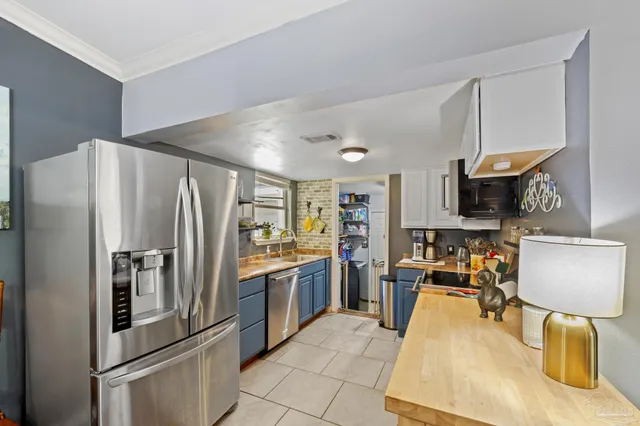 a kitchen with stainless steel appliances granite countertop a stove and a sink