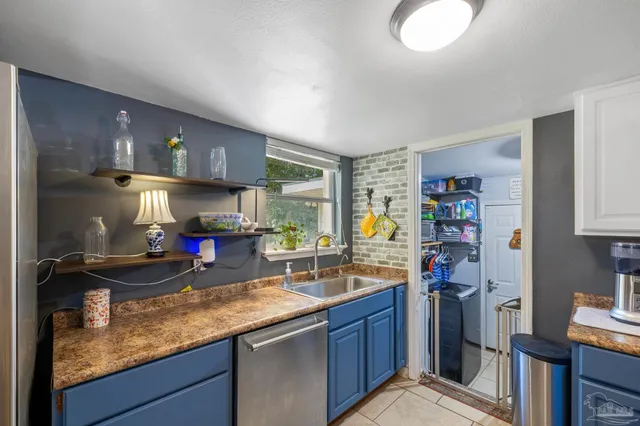 a kitchen with a stove a sink and a refrigerator