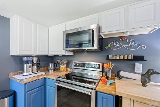 a bathroom with a sink a toilet a mirror and shower curtain