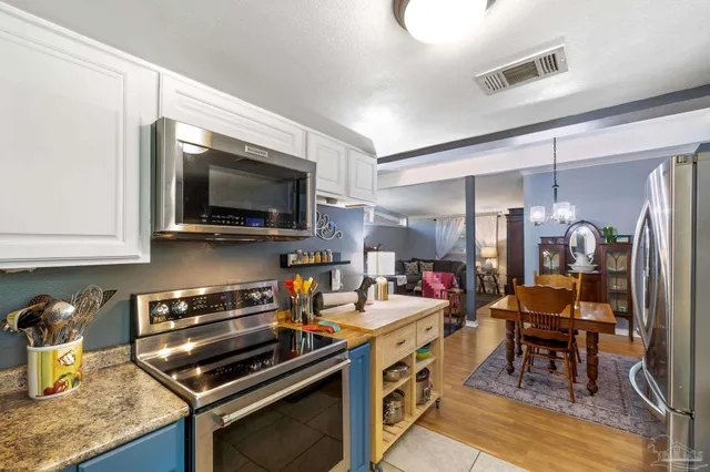 a view of a hallway with bathroom and wooden floor