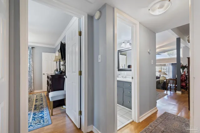 a bedroom with a bed and a painting on the wall