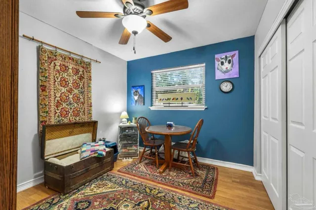 a bedroom with a bed and a painting on the wall