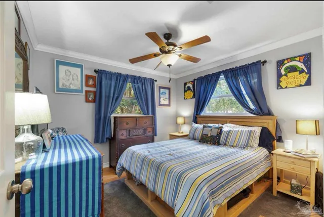 a bedroom with a bed and a flat tv screen on dresser