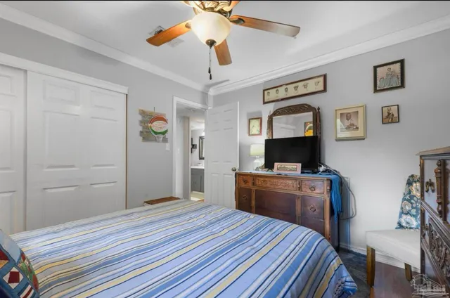 a bedroom with a bed dresser and a window