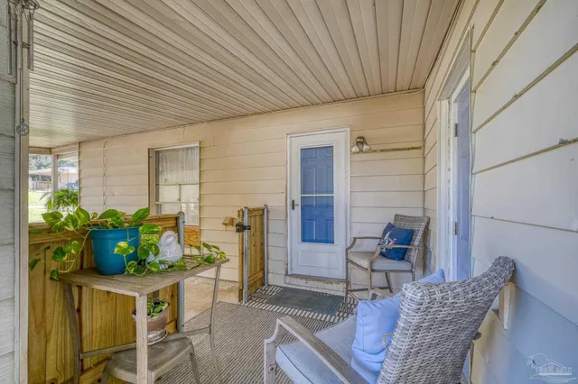 a view of a backyard with a garden and tree
