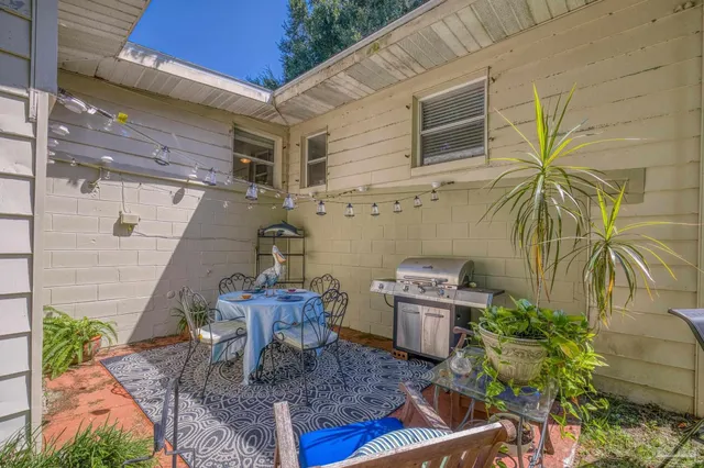 a view of backyard with wooden fence and a slide