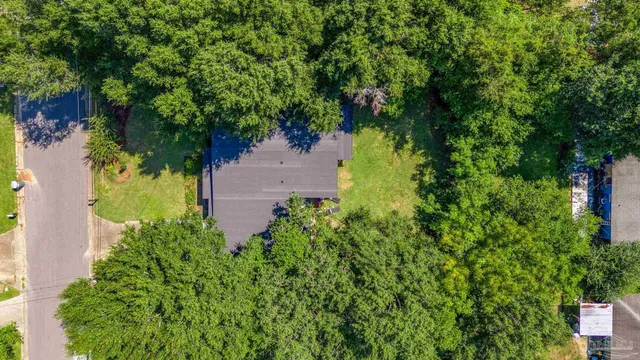 an aerial view of a house with a yard
