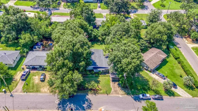 an aerial view of residential houses with outdoor space and street view