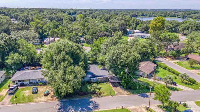 an aerial view of house with yard swimming pool and outdoor seating