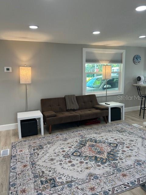 6837 Flicker Lane Hudson, FL 34667 - Photo 11 of 28 a living room with furniture a flat screen tv and a fireplace