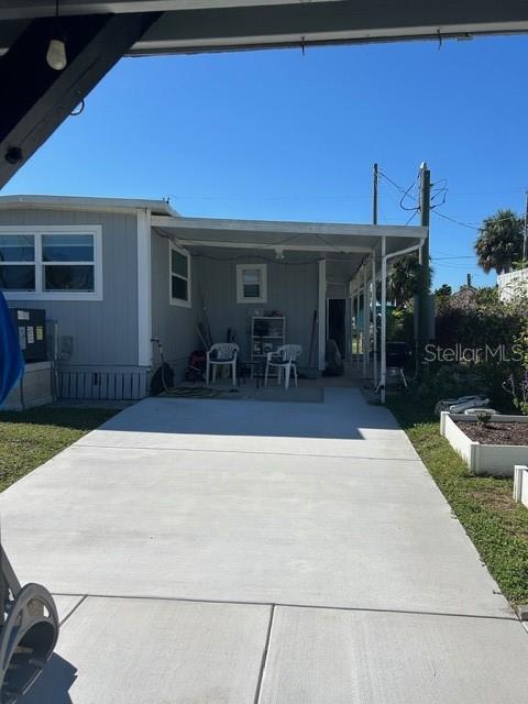 6837 Flicker Lane Hudson, FL 34667 - Photo 2 of 28 a swimming pool with outdoor seating and yard