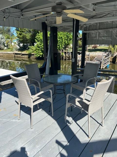 6837 Flicker Lane Hudson, FL 34667 - Photo 27 of 28 a view of a chairs and table in a patio