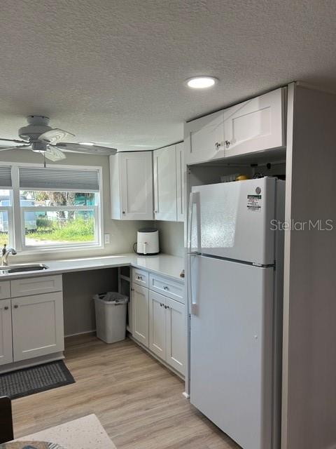 6837 Flicker Lane Hudson, FL 34667 - Photo 4 of 28 a kitchen with stainless steel appliances a refrigerator sink and cabinets