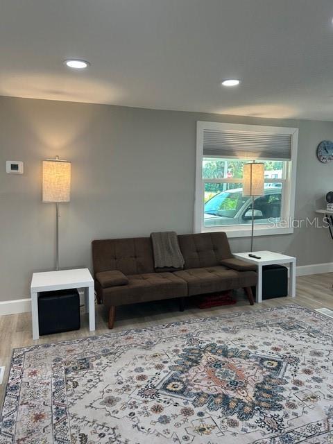 6837 Flicker Lane Hudson, FL 34667 - Photo 10 of 28 a living room with furniture window and a fireplace