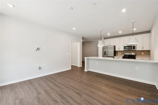 a view of kitchen with stainless steel appliances refrigerator and microwave