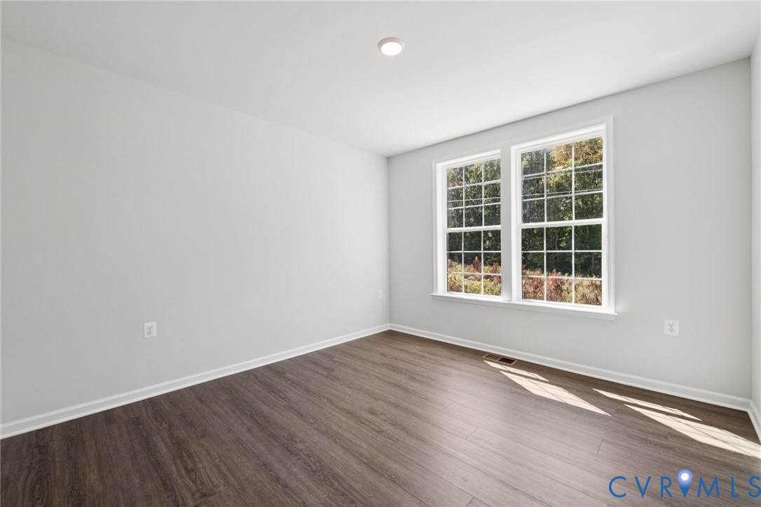 13239 Garland Lane Midlothian, VA 23114 - Photo 14 of 48 a view of an empty room with wooden floor and a window