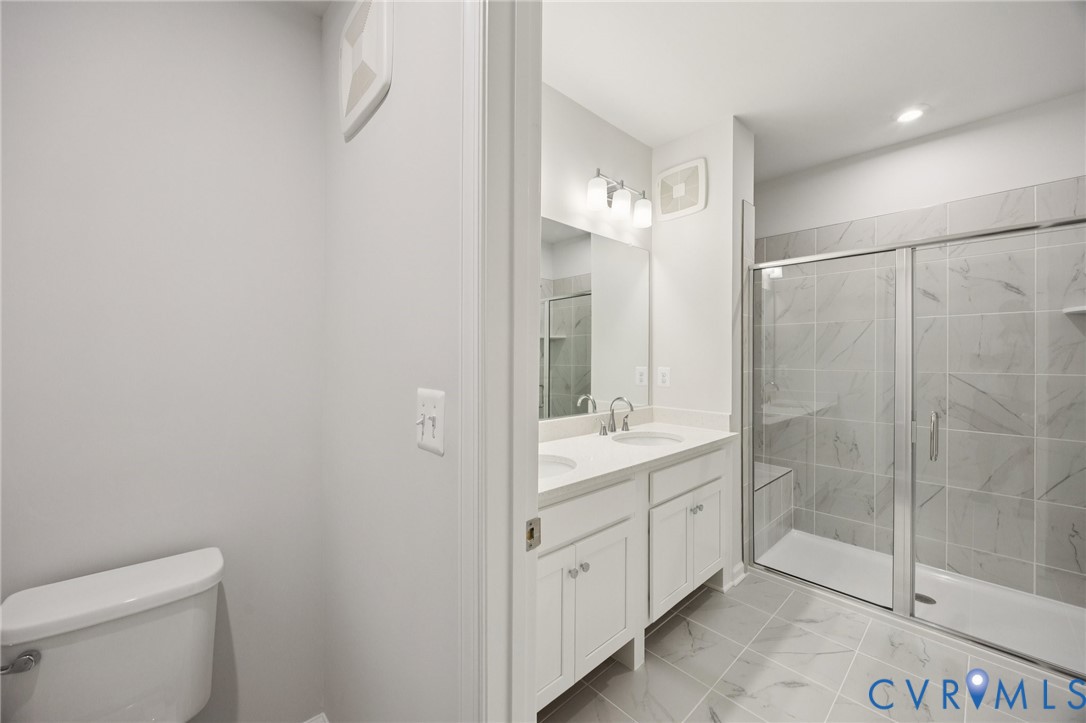 13239 Garland Lane Midlothian, VA 23114 - Photo 18 of 48 a bathroom with a granite countertop sink a toilet and shower