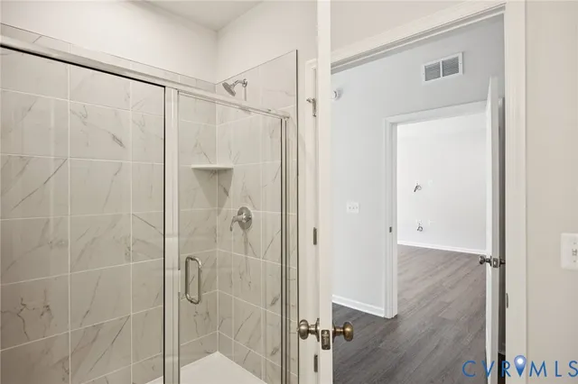 a bathroom with a glass shower door