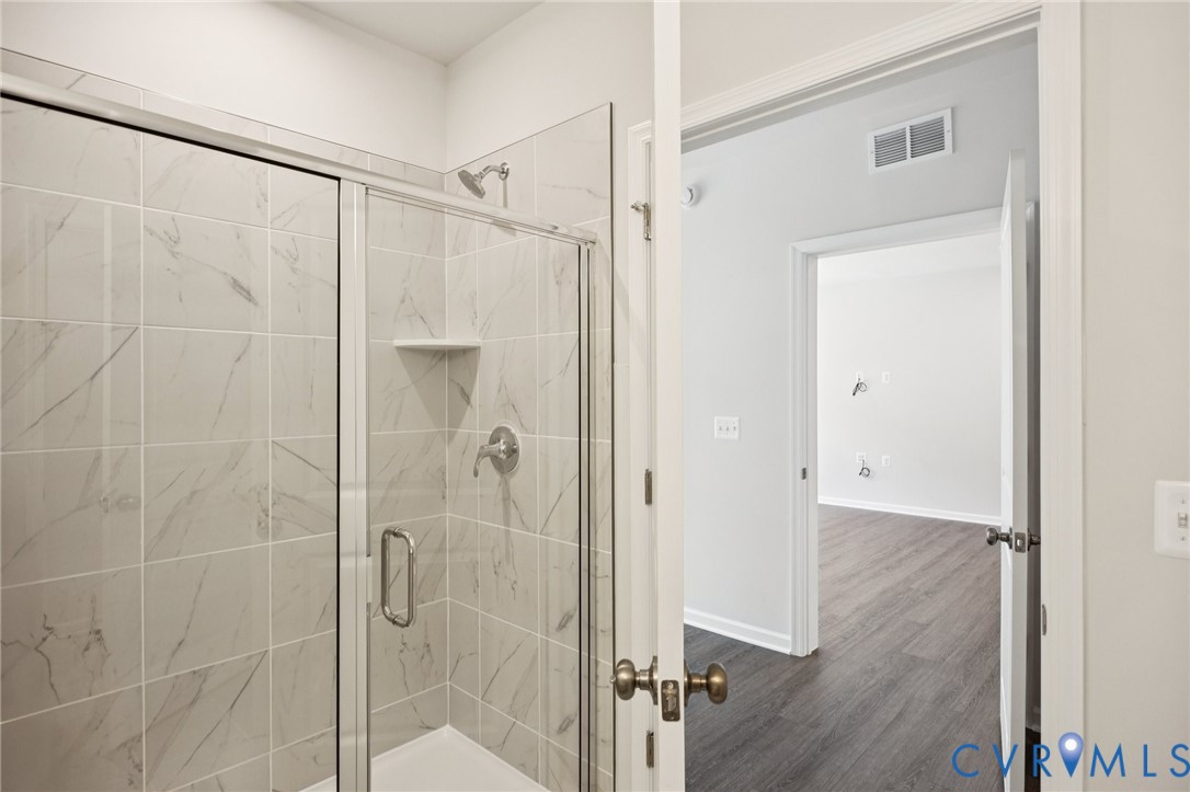 13239 Garland Lane Midlothian, VA 23114 - Photo 20 of 48 a bathroom with a glass shower door