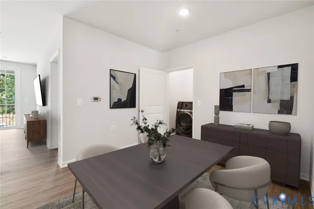 a view of a dining room with furniture and wooden floor