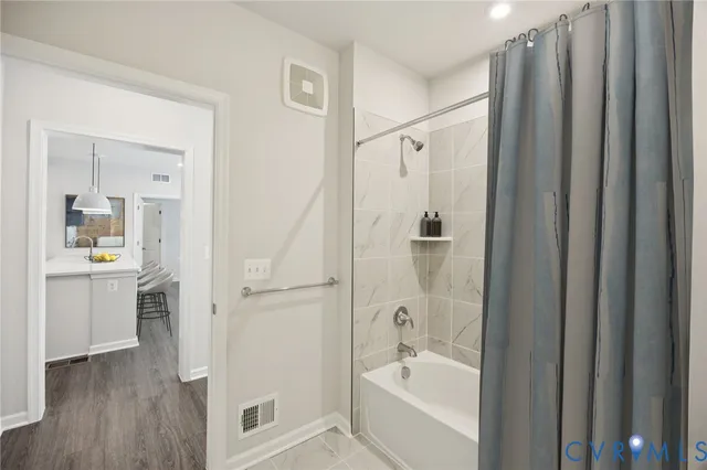 a bathroom with a shower a sink and a mirror