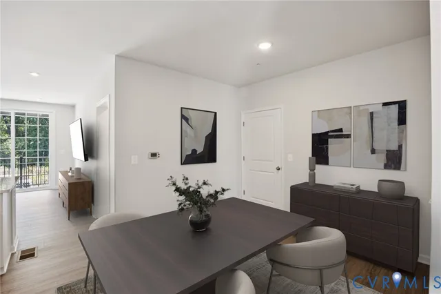 a dining room with furniture and wooden floor