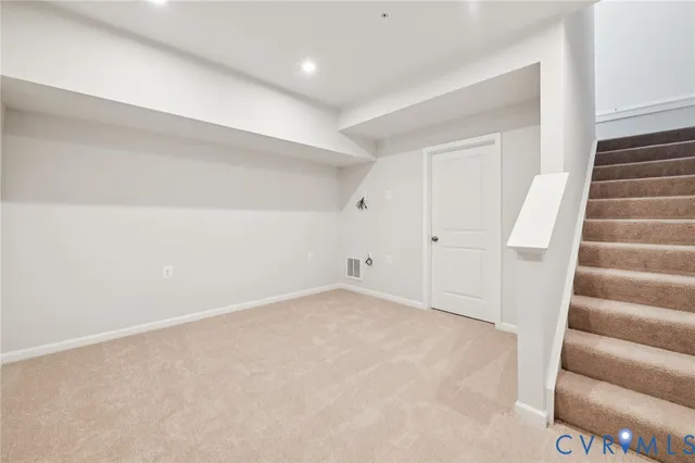 a view of an empty room with stairs