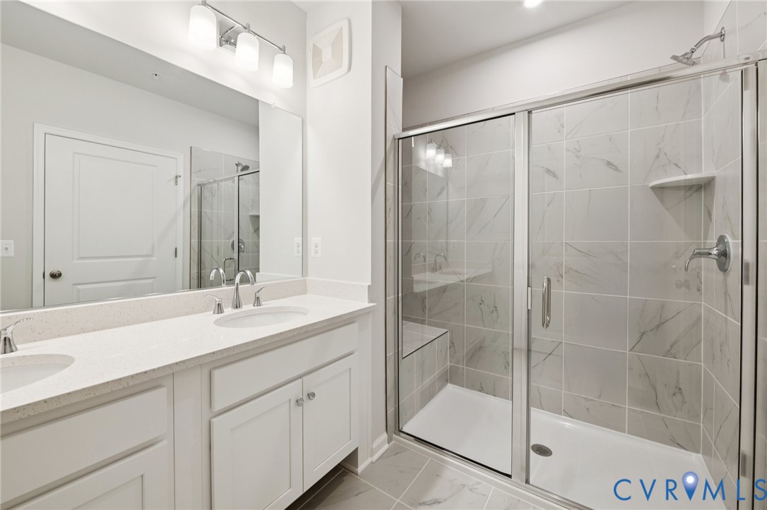 13239 Garland Lane Midlothian, VA 23114 - Photo 33 of 48 a bathroom with a shower sink and mirror