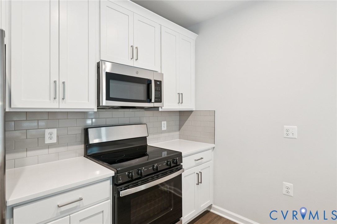 13239 Garland Lane Midlothian, VA 23114 - Photo 7 of 48 a kitchen with granite countertop white cabinets and stainless steel appliances