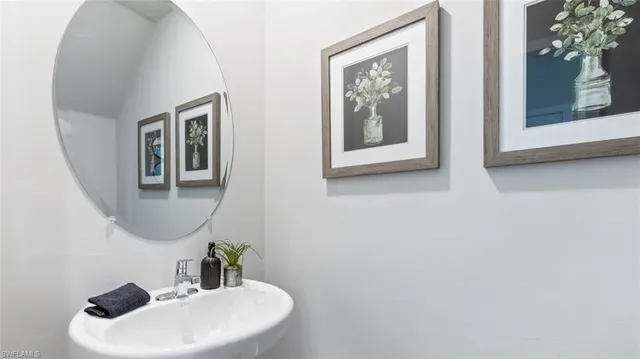 a bathroom with a sink and mirror