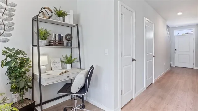 a view of a hallway with workspace and a potted plant