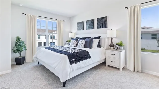 a bed room with a bed and a potted plant