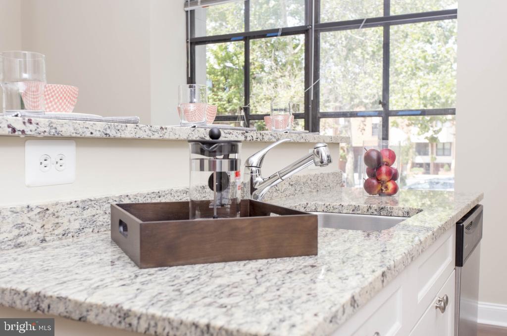 230-38 North 21st Street, Unit 409 Philadelphia, PA 19103 - Photo 2 of 17 a kitchen with granite countertop a sink and a window