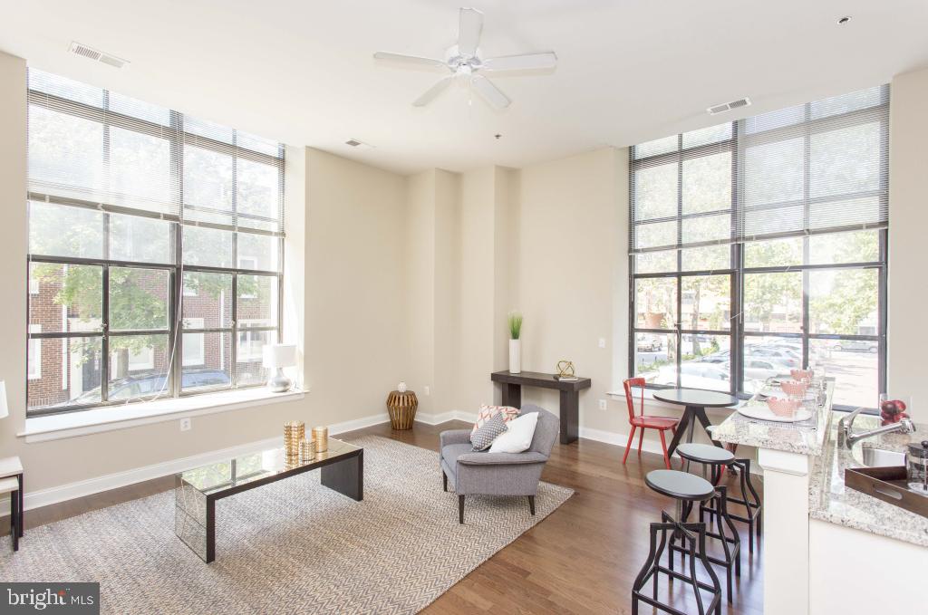 230-38 North 21st Street, Unit 409 Philadelphia, PA 19103 - Photo 5 of 17 a living room with furniture and floor to ceiling windows