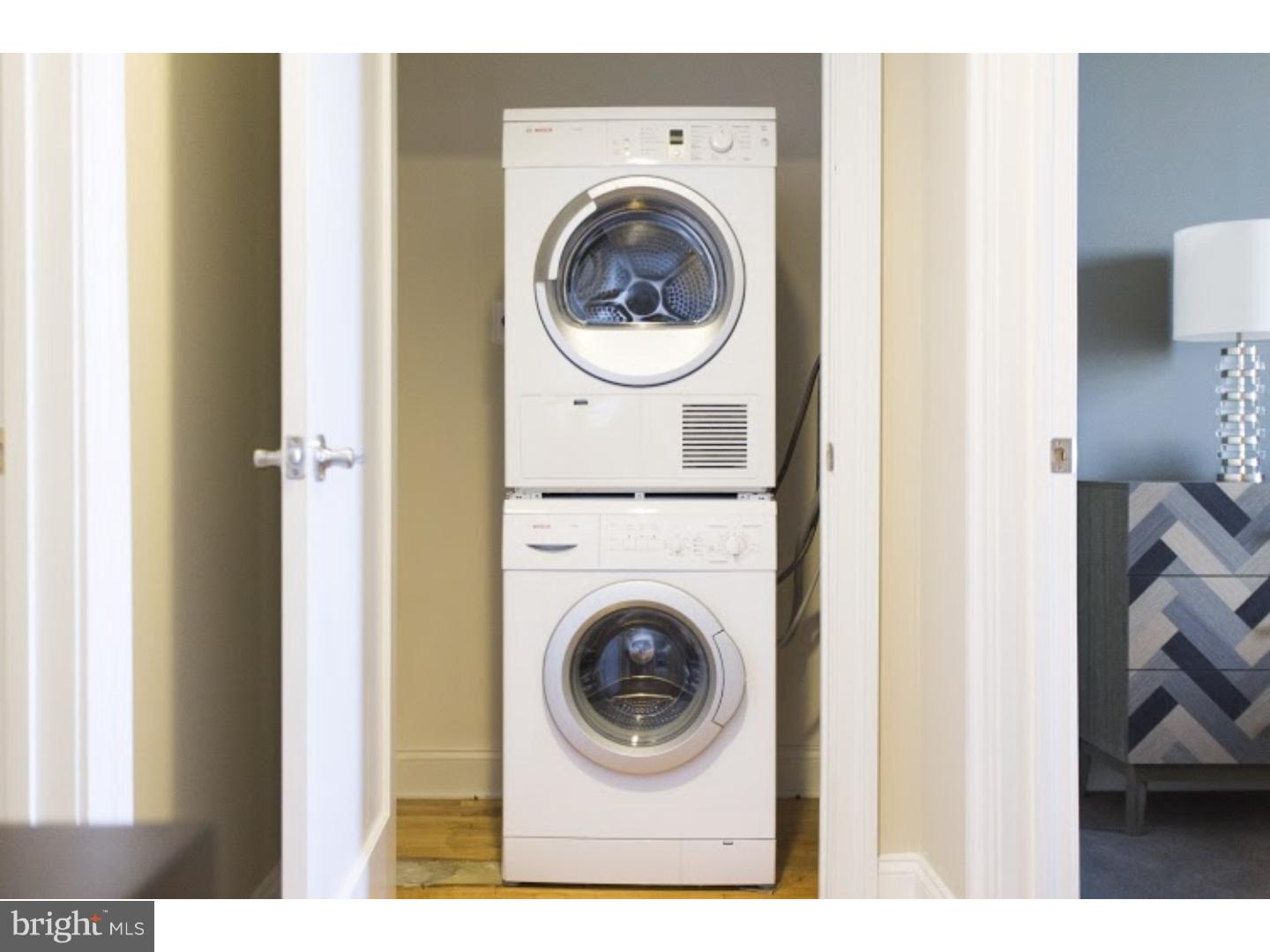 230-38 North 21st Street, Unit 409 Philadelphia, PA 19103 - Photo 7 of 17 a view of a bedroom with washer and dryer