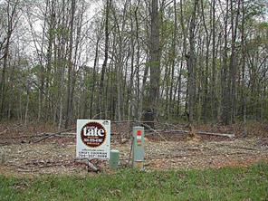 13 Forget Me Not Lane Wingate, NC 28174 - Photo 1 of 1 a sign that is sitting in front of a forest