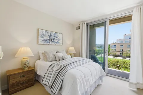 a bedroom with a bed and a painting on the wall