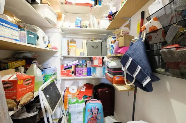 a living room with furniture stairs and a window