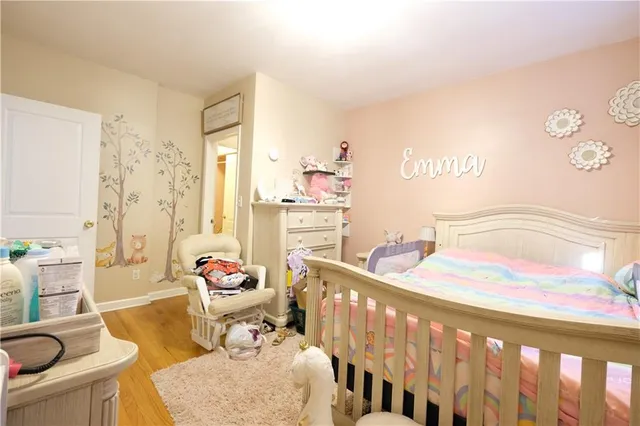 a bedroom with furniture and a large window