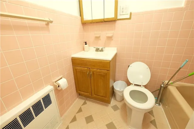 a bathroom with a sink toilet and a mirror